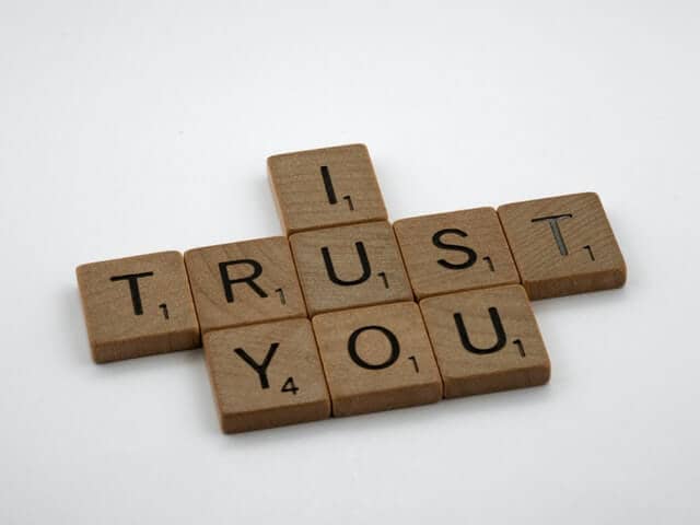 Scrabble letters spelling "I trust you" to denote credibility.